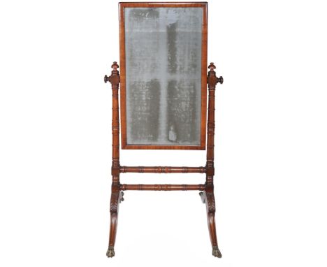  A George IV mahogany cheval mirror  , circa 1825, the rectangular mirror plate within cushion frame and on ring turned suppo