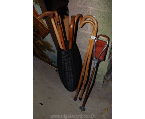 A cane effect stick stand, walking sticks and shooting stick.