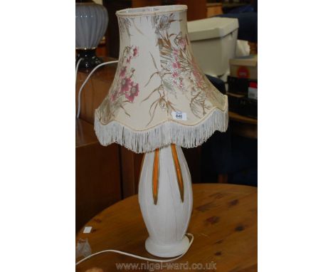 Pottery table lamp with floral shade.