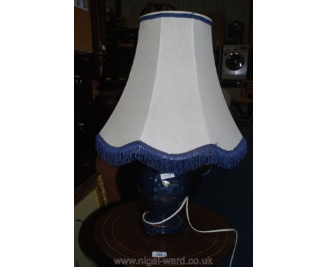 A table lamp with blue base and shade.