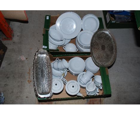Silver edged dinner service including tea and coffee cups, saucers etc and two metal serving trays.