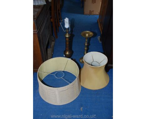 A tall brass table lamp, brass stand and two large lamp shades.