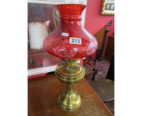 Brass oil lamp with cranberry coloured shade - By Duplex