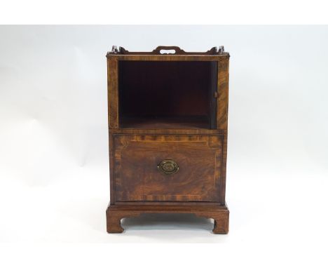 A George III mahogany veneered wash stand with strap frieze over a tambour fronted cupboard over a commode drawer on bracket 