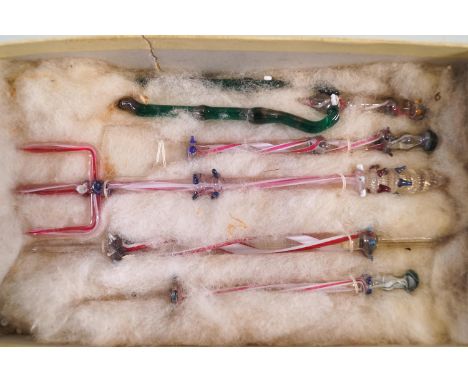 Five early 20th century glass swizzle sticks  in novelty forms, the largest in the form of a fork, 13cm long 