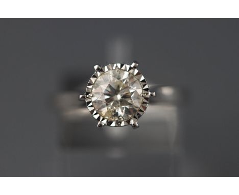 A white metal illusion set single stone diamond ring stated weight of 1.32 carat colour J/K Clarity: I2 Stamped 750 Size M 4.