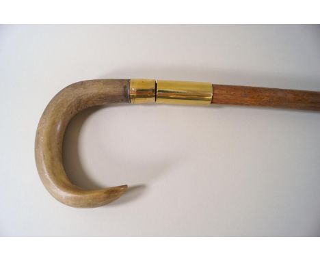 A horn handled walking stick with brass mounts