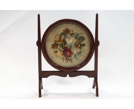 A mahogany framed fire screen with woolwork and carpet work panel, 72cm x 54cm wide