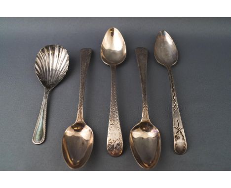 A set of three silver tea spoons with bright cut decoration, another similar and a silver caddy spoon, with shell shaped bowl