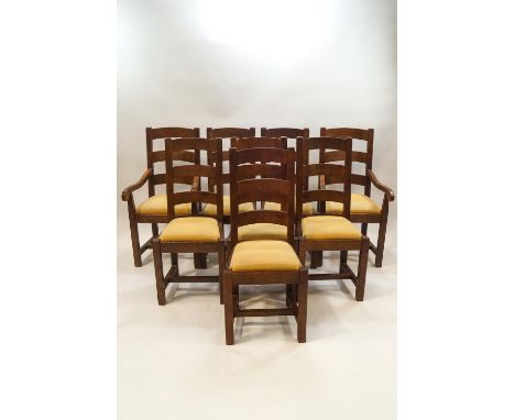 A set of eight oak ladder back dining chairs, including two with arms, each with upholstered drop in seats