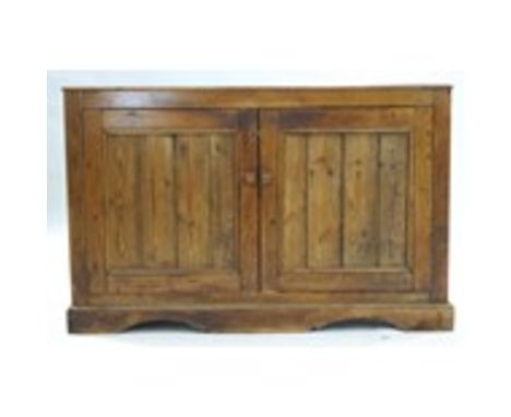 A Victorian pine dresser base, the panelled doors enclosing one shelf, 99cm high x 154cm wide x 53cm deep