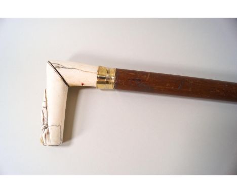 A walking stick, the late Victorian ivory handle carved with Mr Punch's dog Toby