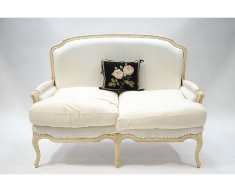A 20th century French style two seater sofa, painted cream, 96cm high x 137cm wide, and a matching armchair