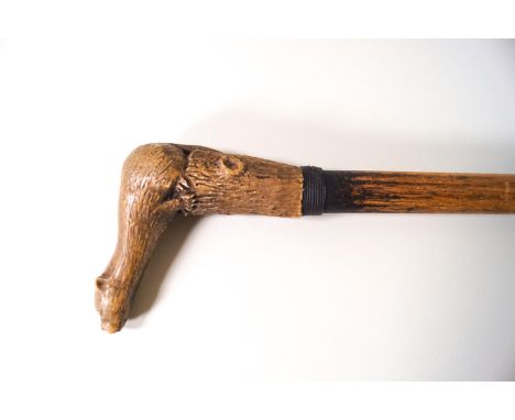 A walking stick with carved limestone handle in the form of an otter