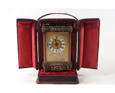 A late 19th/early 20th century carriage clock in leather travelling case, 17cm high