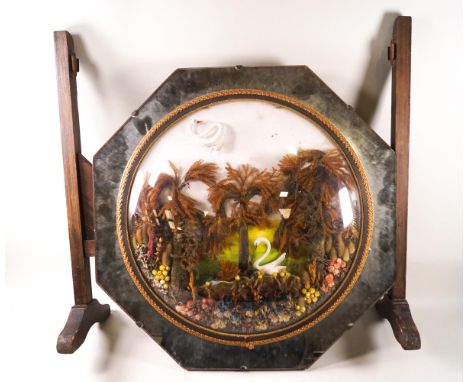 A Victorian and 1930's combined fire screen with domed glass panel enclosing a dried flower and leaf landscape