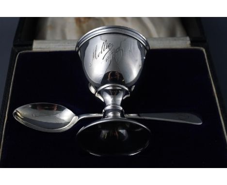 A silver christening egg cup and spoon, cased, both inscribed, London 1921, 35 grams gross