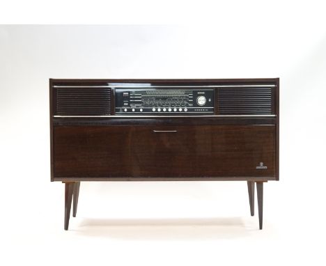 A Grundig radiogram with record player in the cabinet below, on tapering legs, 70cm high x 118cm wide x 36cm deep