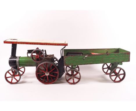 A Mamod tin plate traction steam engine and cart, with original paper leaflet, overall 60 cm long