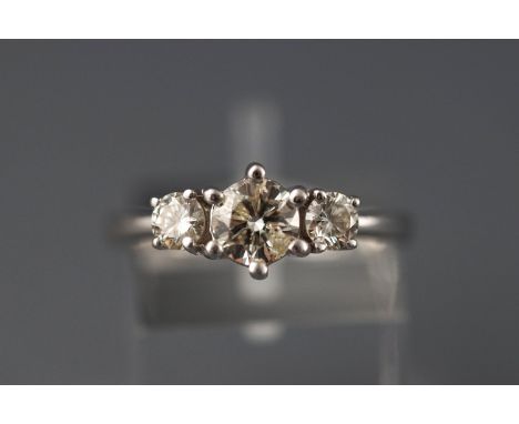 A white metal three stone diamond ring, approx 1.00ct. Hallmarked 18ct gold, London. Size: N 4.0 grams Centre stone K/L I1 ap