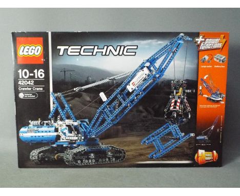 LEGO - A boxed Lego Technic powered Crawler Crane # 42042, its still factory sealed and the box has only light storage marks.