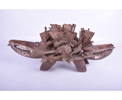 A Two-headed dog sculpture, Kongo, Zaire
The carved wooden sculpture in the form of a stylised dog, applied with nails and me