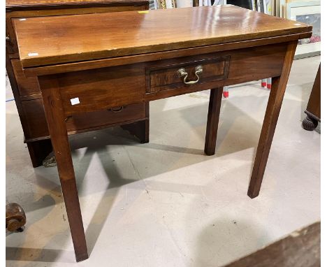 A mahogany fold over card table on square canted legs with single drawer. 