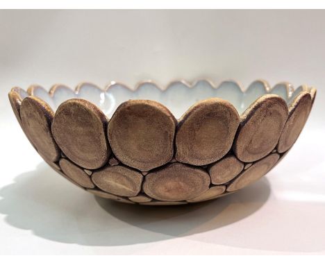 An unusual Studio pottery bowl with white glazed interior with scale like exterior Thornell signed