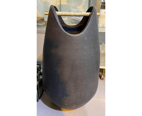 A large modern ovoid pottery floor standing vase/stick stand in black finish 