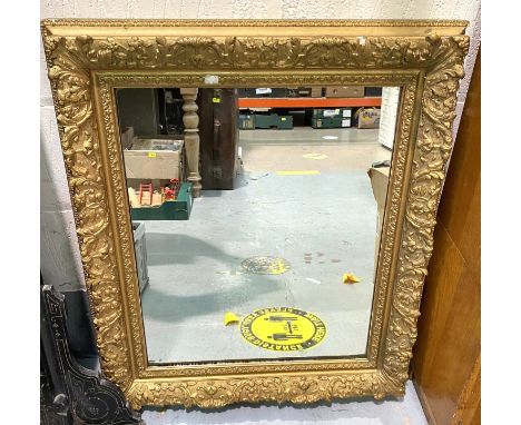 A late 19th/early 20th century rectangular wall mirror in ornate gilt frame, length 87cm 
