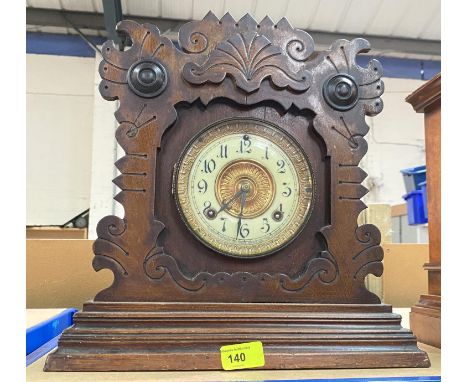 A clock in carved wooden case with naturalistic decoration, American movement 