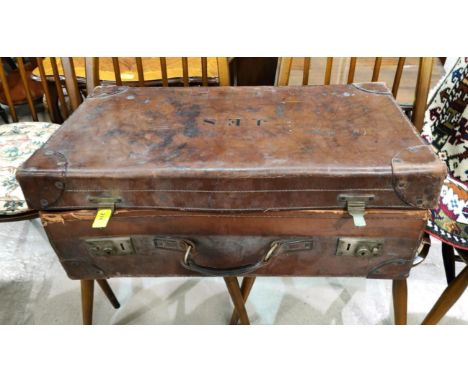 A vintage leather suitcase, bears initials 'J.E.M.', with stickers; a selection of handbags; etc. 
