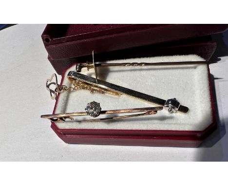 A bar brooch set with a diamond stamped 9 ct; an 18 ct stud and a stick pin 