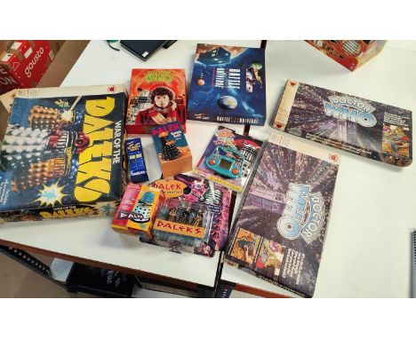 A clockwork Dalek, boxed; a vintage handheld Dalek game; a vintage board game (not guaranteed complete) 