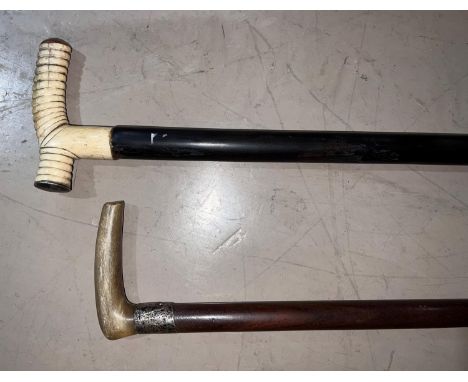 An antique walking stick with horn handle and silver finial and another with bone handle, white metal and tortoiseshell milit