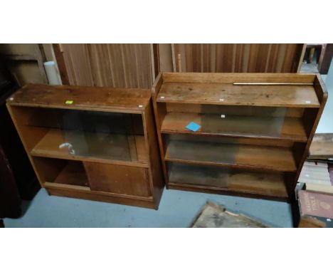 A 1950's light oak 3 height bookcase enclosed by sliding glass doors; a similar 2 height bookcase 