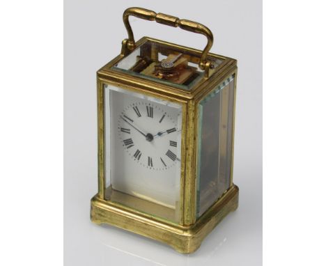 A brass cased carriage clock, bevel glass case, Roman numerated chapter ring, 11cm high (excluding handle)