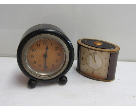 A Jaeger 8 days alarm carriage/desk clock and an ebonised desk clock on bun feet (2)