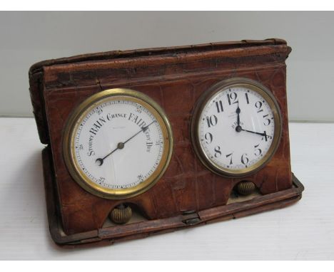 An Asprey, London travelling clock/aneroid barometer in crocodile skin case, glasses cracked