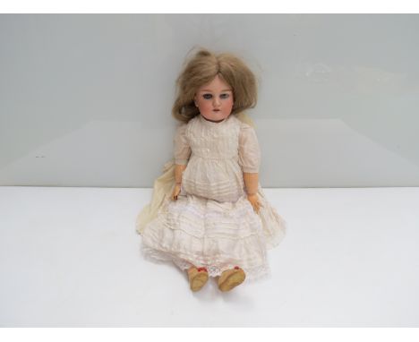 A 21" German bisque headed doll, in white dress and shoes, marked "C4" to back of head, with sleepy eyes 