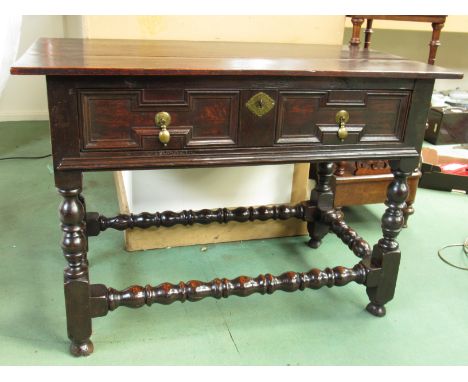 A circa 1700 oak serving table the three plank top over a single drawer with geometric decoration on bobbin turned legs and s