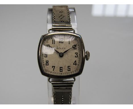 ROLEX: An 18ct white gold lady's bracelet watch with cushion case, silvered Arabic dial, 15 jewel manual movement, bracelet c