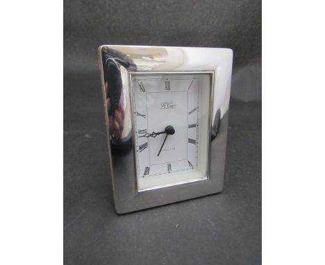 A Harrods silver framed desk clock with quartz movement, 12cm high