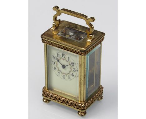 A late 19th/early 20th Century French brass carriage clock with Arabic enamelled dial, link decoration to case, with key, 11.