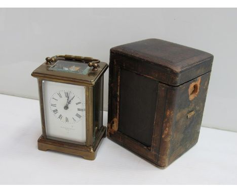 An early 20th Century French brass carriage clock with Roman enamelled (hairlined), signed Elkington & Co. Paris, with key an