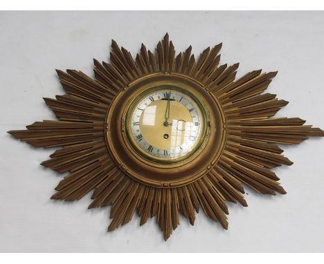 A gilded sunburst from wall clock with brass dial and silvered Roman chapter ring, 62cm diameter