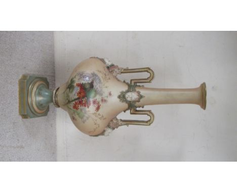 A late 19th Century Royal Worcester porcelain two - handled pedestal vase applied with marks to neck and handle terminals, th