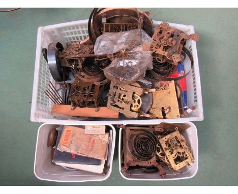 Three boxes of clock movements, spares, mainsprings etc