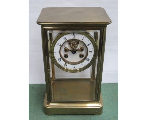 A 19th Century French brass cased four glass mantel clock, Roman enamelled chapter ring with 8 day striking movement and visi