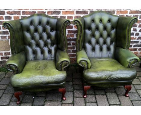 Pair of leather button back winged armchairs.